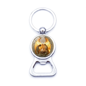 Detail of metal silver beer bottle opener keychain with a religious themed image inlay
