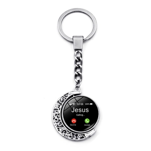 Close-up of rotatable moon keychain featuring a Jesus Calling phone interface design