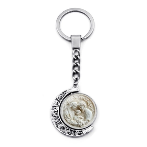 Detail of silver crescent moon keychain featuring a Holy Family relief medallion charm