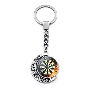 Macro detail of rotating dartboard moon keychain with silver metallic finish