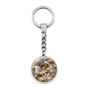 Close-up of a silver Holy Family pendant keychain with detailed rose border relief