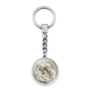 Macro detail of the religious Holy Family relief on the round silver metal keychain