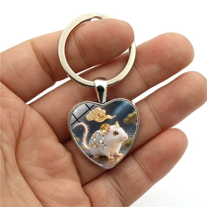 Heart-shaped metal keychain featuring a white rat illustration with golden cloud patterns