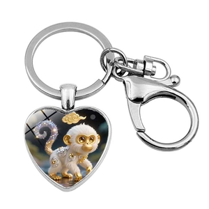 Detail of heart-shaped metal keychain featuring a 3D monkey zodiac illustration and clasp
