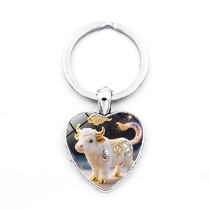Silver heart-shaped keychain with gold Ox zodiac pendant and Chinese cloud motifs