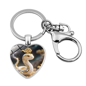 Silver heart-shaped metal keychain with artistic snake illustration and ring clasp