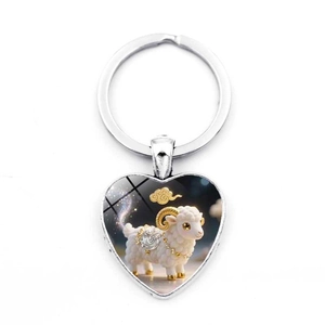 Detail of a silver heart-shaped keychain featuring a 3D cartoon sheep with gold accents
