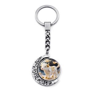 Polished silver metal zodiac ox keychain featuring double-sided rotating moon pendant