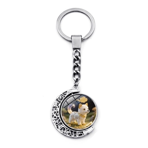 Detail of creative rotating moon keychain with a cute cartoon zodiac dog pendant