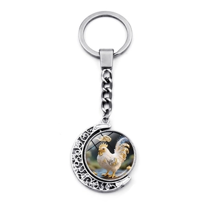 Detailed view of silver crescent moon keychain with rotating 3D zodiac rooster pendant