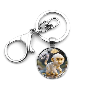 Detailed macro view of the metal lobster clasp and keychain with glass monkey charm