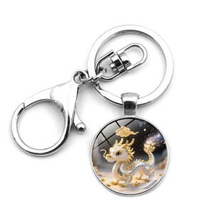 Detailed view of silver metal keychain with a cute dragon illustration in glass dome