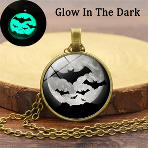 Gothic bat necklace with glowing green moon pendant on a vintage bronze chain