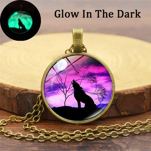 Howling wolf glow in the dark necklace with purple starry sky pendant on wood background