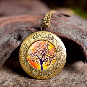 Macro detail of Tree of Life locket with bronze floral relief on natural bark background
