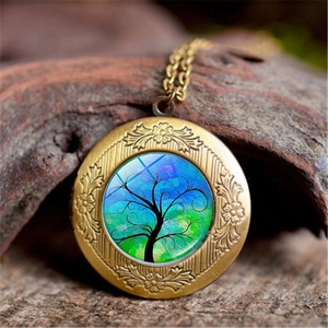 Detailed close-up of vintage bronze tree of life locket on a natural rustic bark background