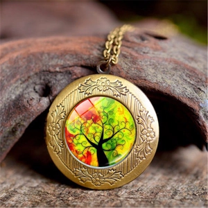 Close-up of retro Tree of Life glass pendant on rustic tree bark with bronze chain