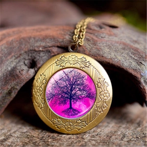 Close-up of tree of life pendant with purple glass inlay on natural wood background
