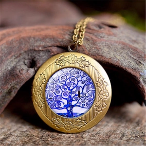 Macro detail of Tree of Life locket with vintage brass floral engraving and glass inlay