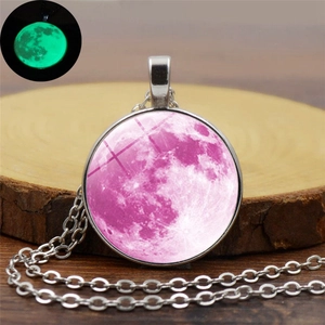 Gros plan du collier lune rose montrant l'effet lumineux dans des conditions sombres