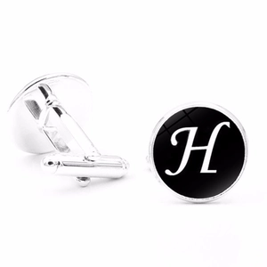 Detailed view of silver letter H cufflinks with bullet back closure on white background