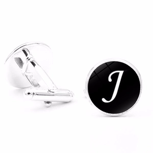Detailed view of silver letter J cufflinks with black background and bullet back closure