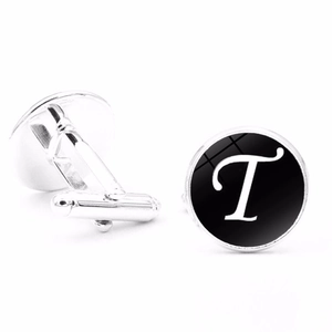 Detail showing polished silver cufflinks with black face and elegant white letter T design