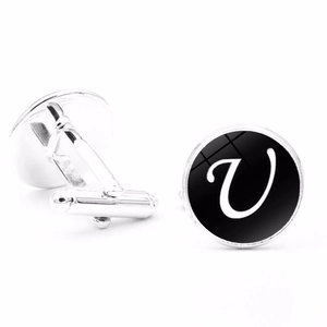 Detail view of silver men's cufflinks featuring a black polished surface and letter V