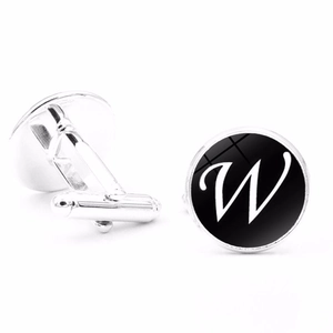 Detailed view of silver letter W cufflinks with polished finish and black enamel round face