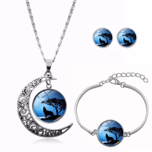Three-piece jewelry set featuring howling wolf moon pendants on necklace, bracelet and earrings