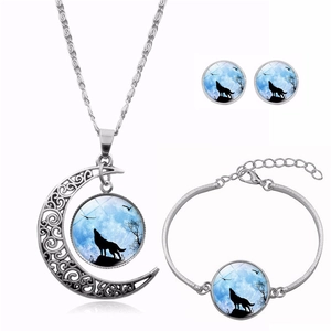 Detailed set of silver howling wolf moon necklace, round earrings and matching bangle