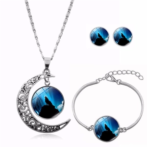 Detailed view of silver howling wolf moon jewelry set with necklace, bracelet and earrings