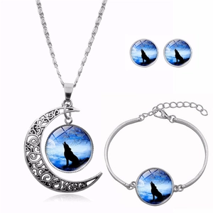 Detailed close-up of howling wolf moon glass gem necklace, bracelet and earring set