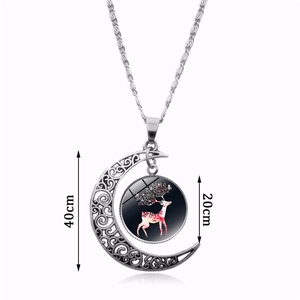 Detailed view of howling wolf glass gem necklace with silver crescent moon pendant