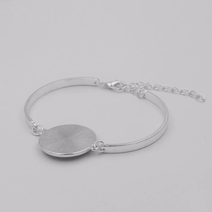 Detailed back view of silver tone adjustable bracelet with textured metal base