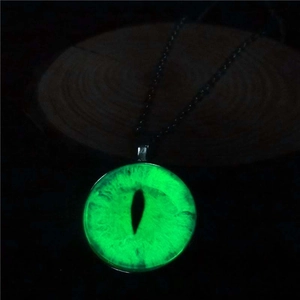 Macro detail of a luminous dragon eye pendant with vibrant green glow in the dark effect