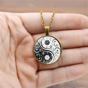 Luminous Yin Yang Tai Chi necklace with retro bronze alloy pendant and spiral design