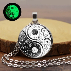Detailed view of luminous Yin Yang necklace pendant showing green glow in the dark effect