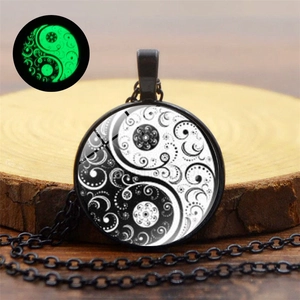 Detailed macro view showing the green luminous effect of the Yin Yang Tai Chi glass pendant