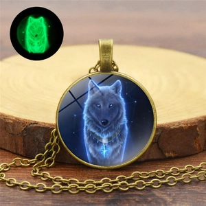 Glow-in-the-dark wolf pendant necklace showing the green luminous effect in darkness