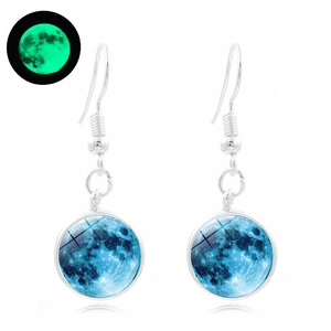 Detailed view of luminous galaxy moon earrings featuring green glow-in-the-dark glass pendants