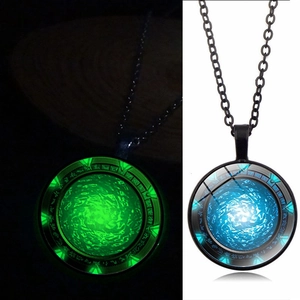 Detailed comparison of glowing circular pendant showing green and blue luminescence effects