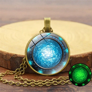 Vintage bronze Stargate Atlantis necklace with glowing blue energy swirl glass pendant