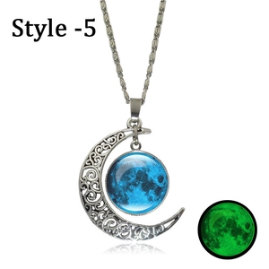 Detailed close-up of crescent moon pendant showing intricate patterns and luminous glow