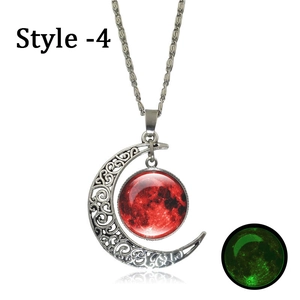 Detailed view of luminous crescent moon pendant with red moon glass and glowing effect
