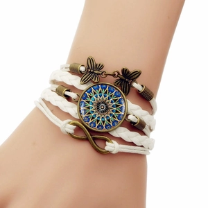 Détail du bracelet bohème multicouche avec gemme mandala et breloques papillon