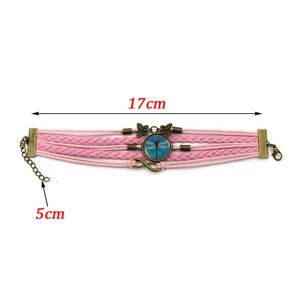 Detail view of pink multi-layer woven bracelet with dragonfly pendant and 5cm extension chain