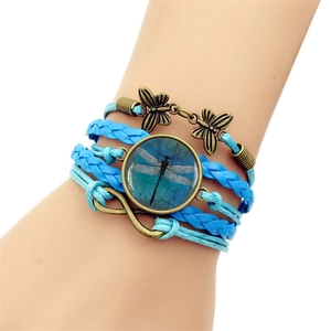 Detail of multilayer woven bracelet with dragonfly pendant and infinity symbol