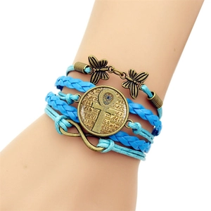 Detail view of multilayer woven leather bracelet with Ankh pendant and butterfly charm