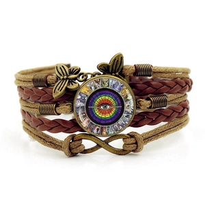 Detail of vintage multilayer braided bracelet with tarot glass gem and infinity charm